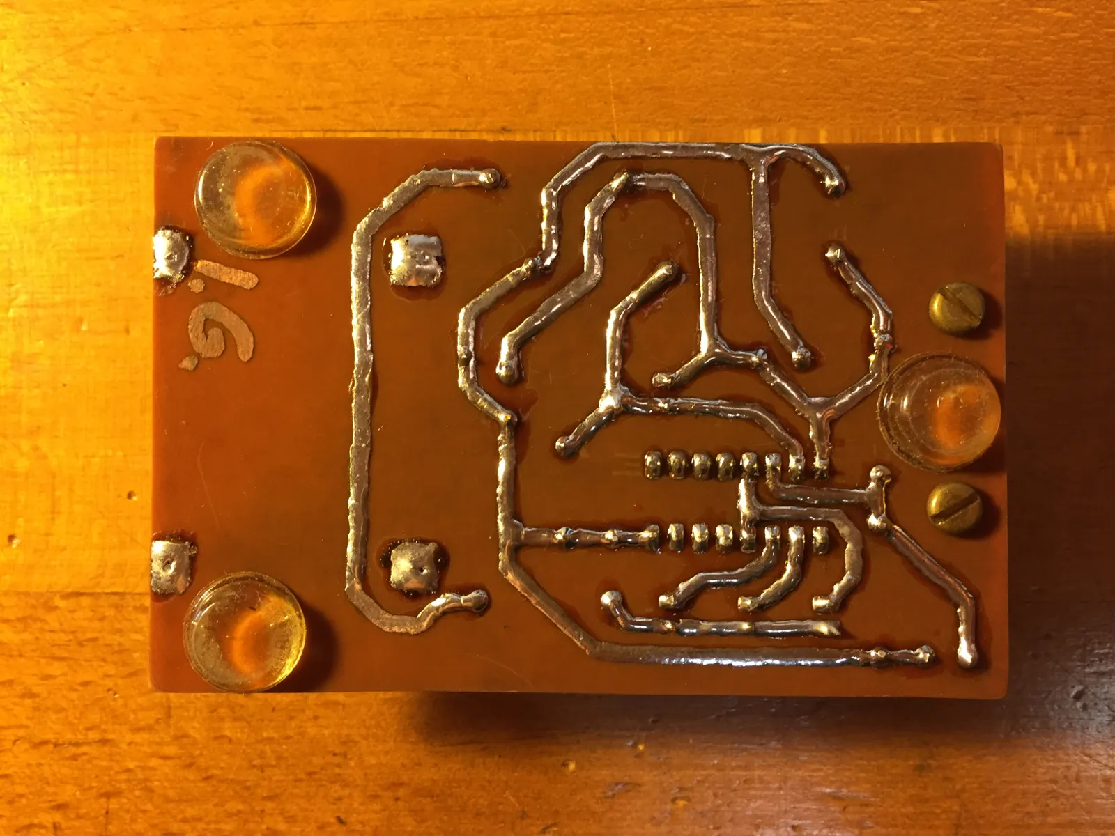 Freshly etched PCB with visible copper traces after ferric chloride etching