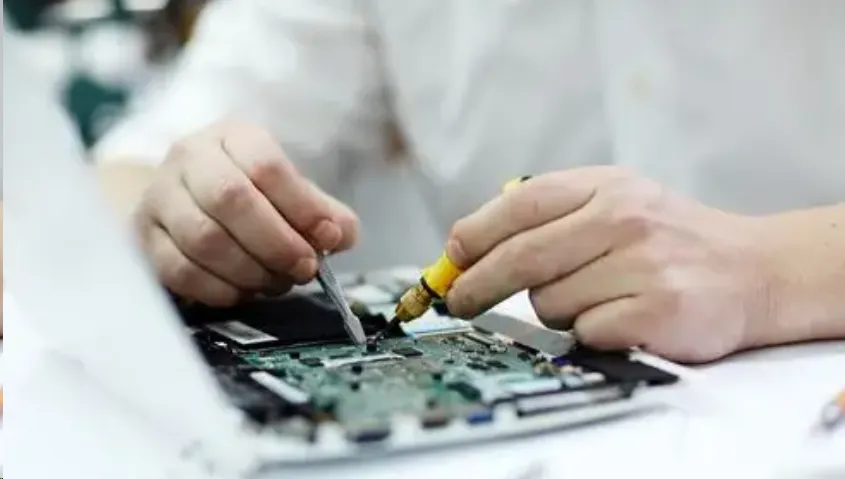 Technician repairing PCB surface finish defect.