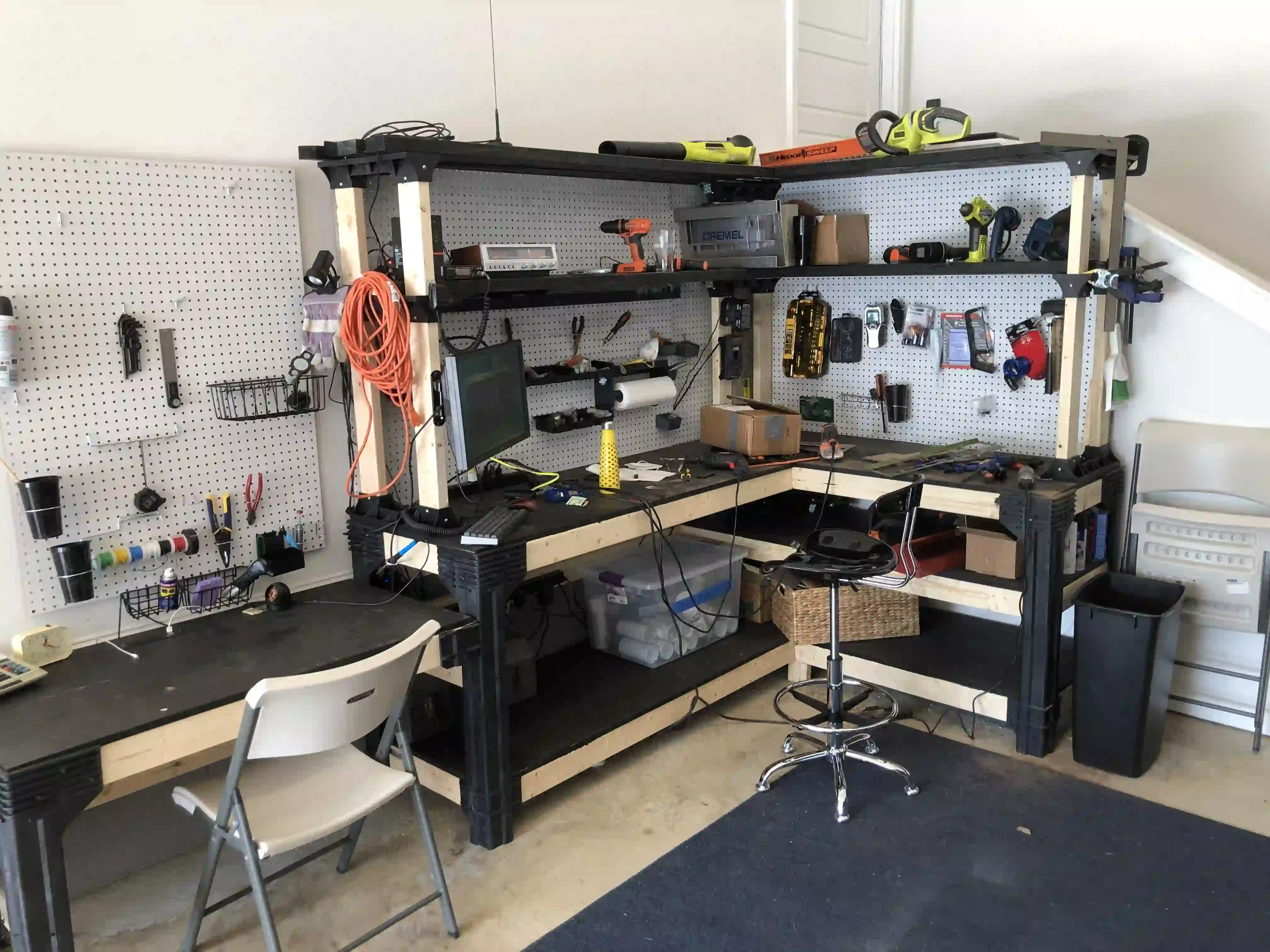 Organized workbench with essential soldering tools for PCB assembly.