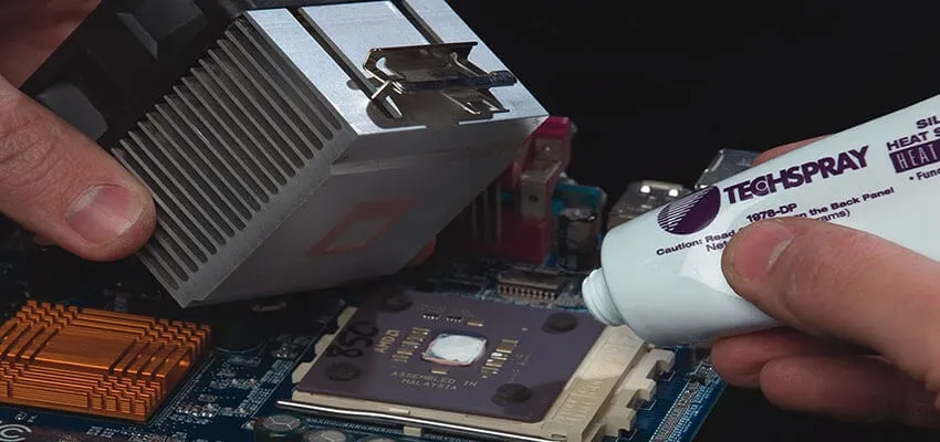 Applying thermal adhesive for permanent heat sink mounting on a PCB.