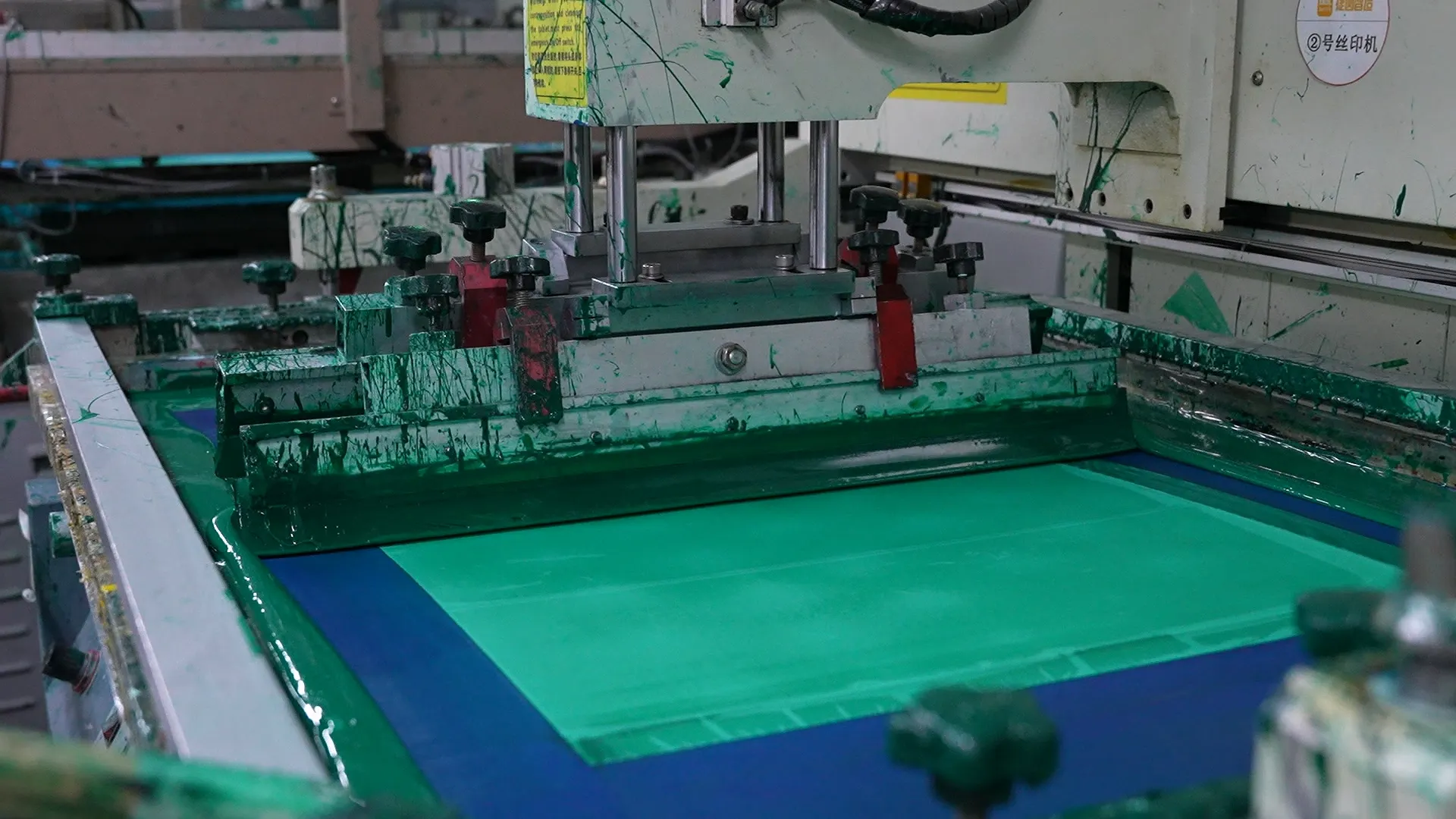 Green solder mask being applied to a PCB during manufacturing process