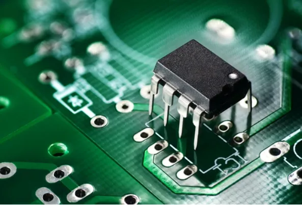 Close-up of leads inserted into PCB vias for THT assembly
