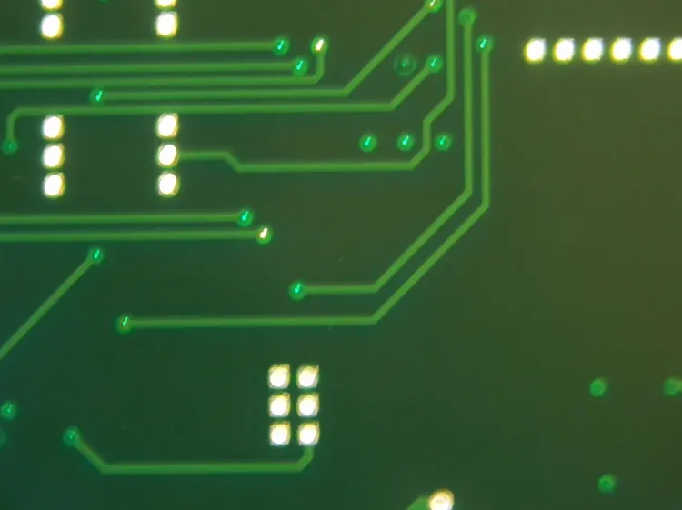 Cross-section of PCB showing tented and untented vias with solder mask.
