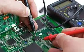 Testing an assembled FR-4 PCB with a multimeter for continuity and shorts