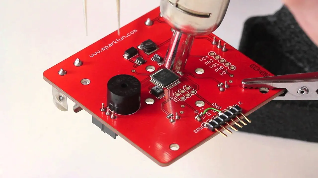 Hot air rework station removing solder bridge on a PCB.