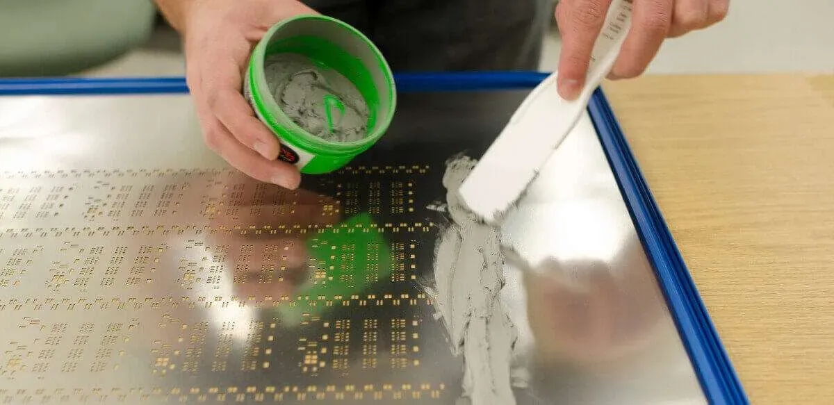Picture Placement: Insert an image here showing a close-up of solder paste being applied to a PCB with a stencil. ALT Text: "Solder paste application on PCB using stencil for SPI process."
