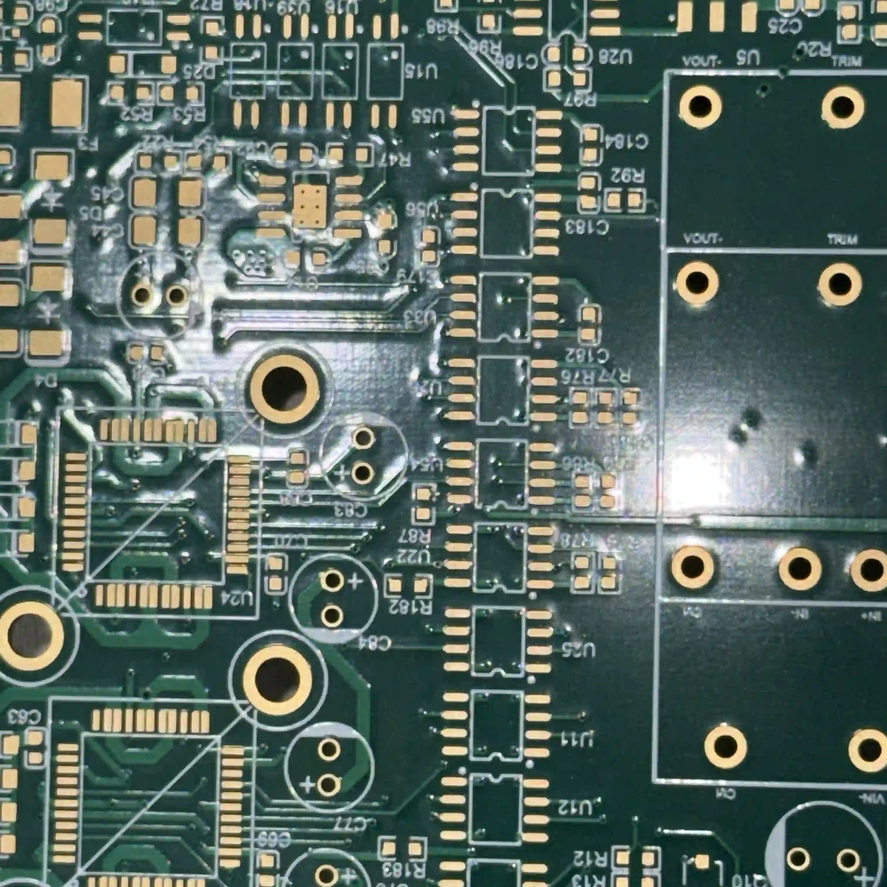 PCB inspection under various lighting conditions showing silkscreen color visibility.