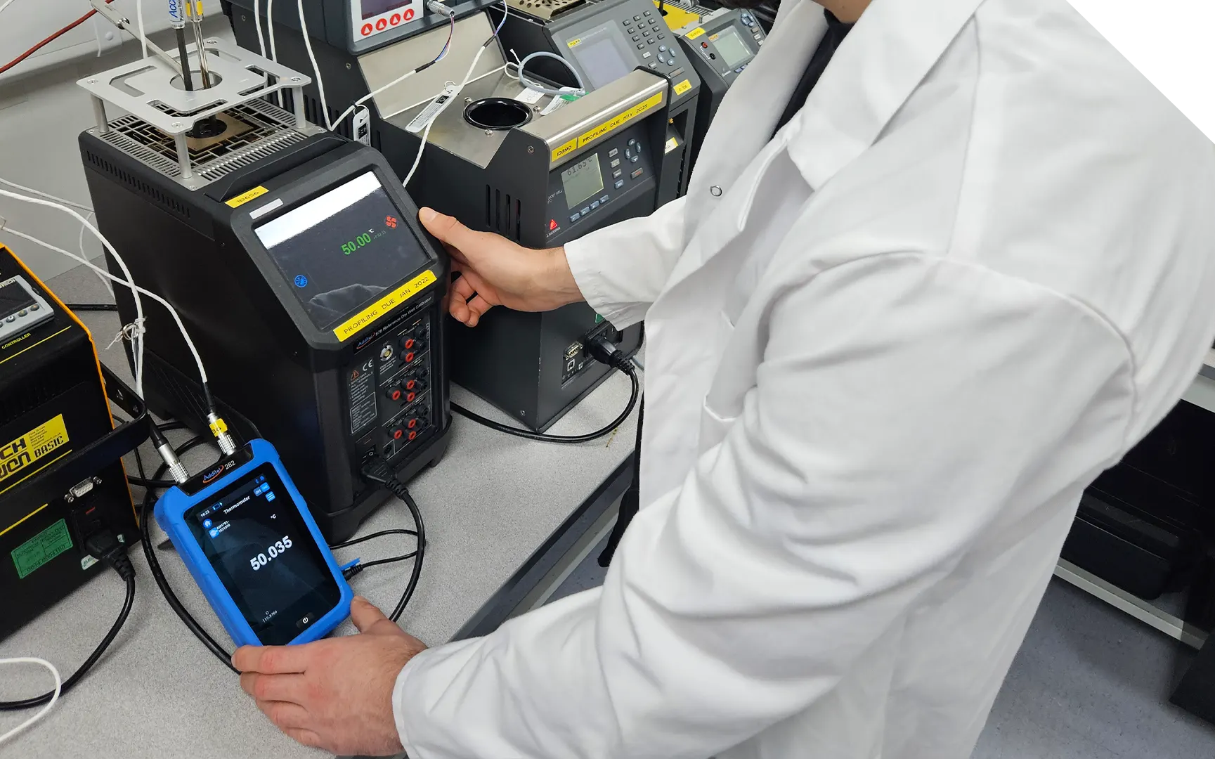 Technician calibrating a thermocouple for thermal profiling accuracy.