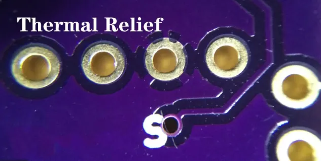 Thermal relief pad design with spoke pattern on PCB.