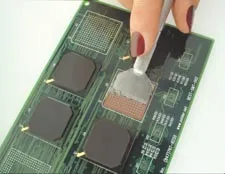 Applying solder paste using a BGA stencil on PCB pads.