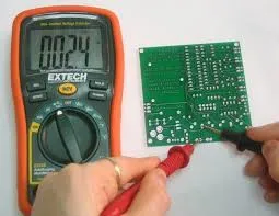 "Testing PCB traces for continuity using a multimeter during DIY PCB diagnostic."