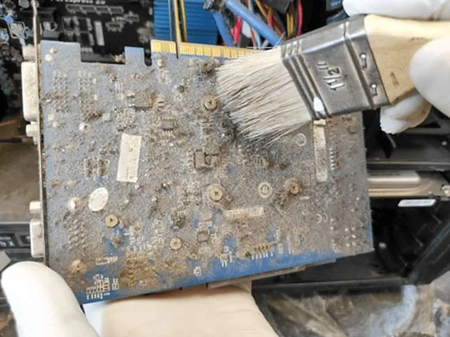 Dirty printed circuit board with flux residue and contaminants.
