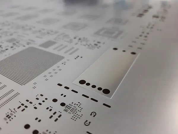 Laser cut stencil for fine-pitch PCB components showing precise apertures.