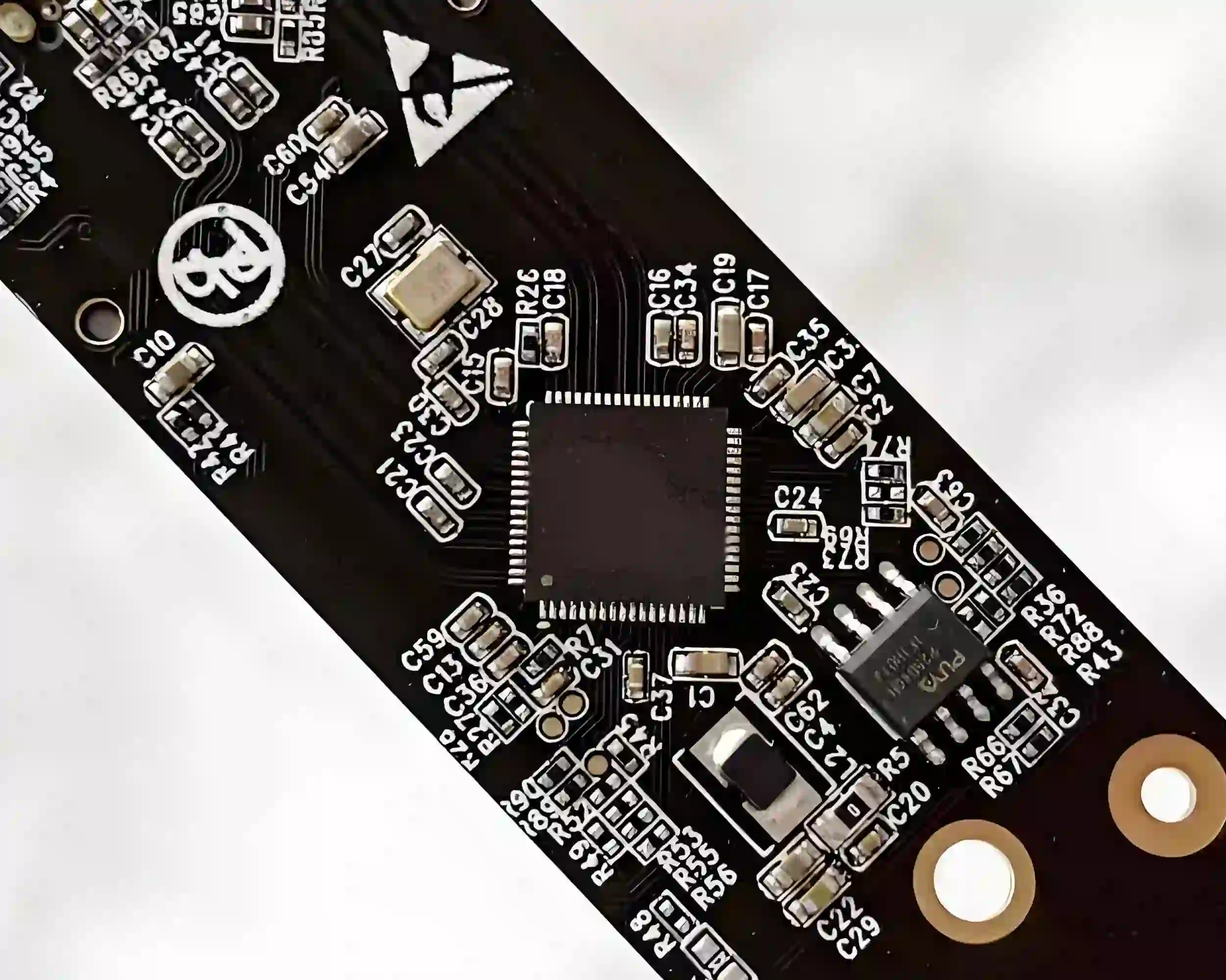 High contrast solder mask with white silkscreen on black PCB.