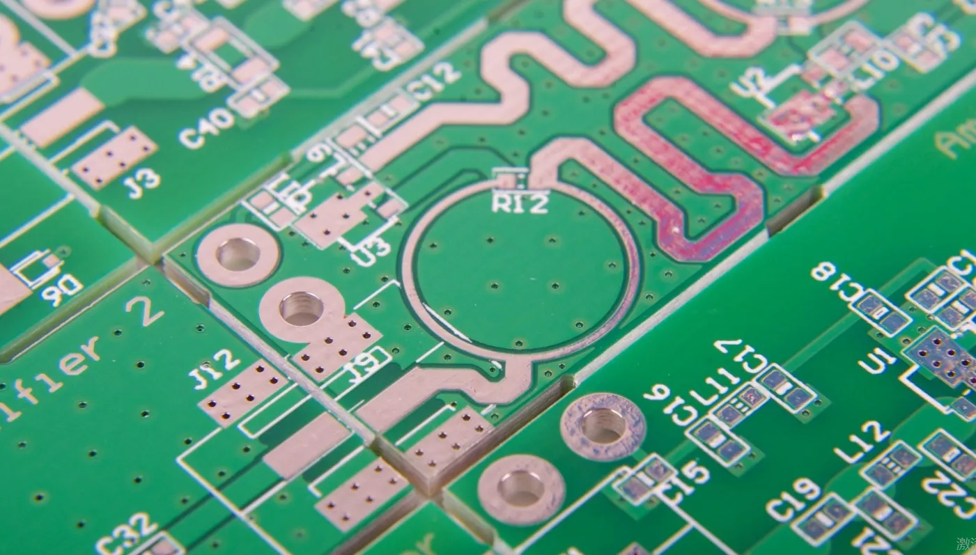 Close-up of a green PCB with solder mask protecting copper traces