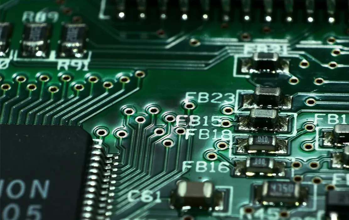 PCB design layout highlighting green solder mask clearances and via tenting