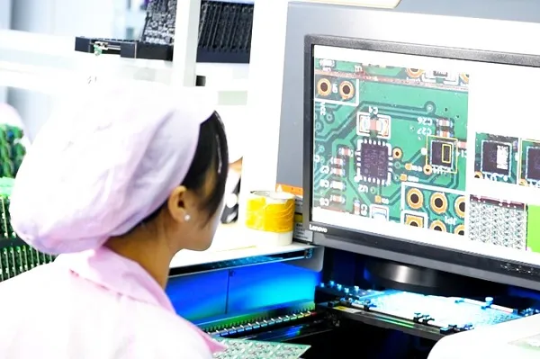 AOI machine inspecting a PCB for defects during manufacturing.