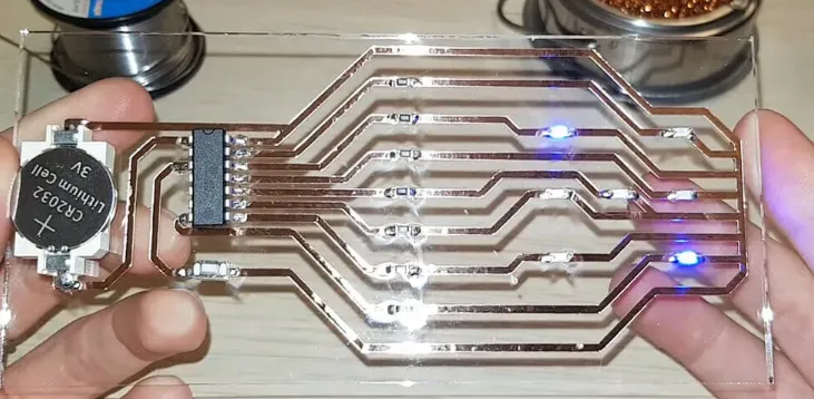 Comparison of transparent PCB made with glass and traditional opaque PCB."