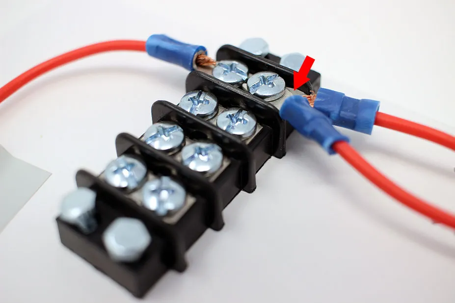 Close-up of a terminal block used in DIY electronics with wires securely connected.