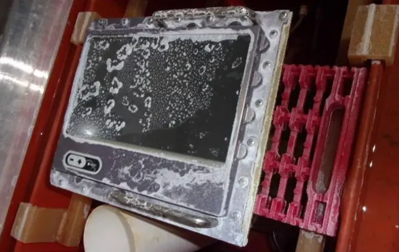 Testing marine PCBs in a salt fog chamber for reliability.
