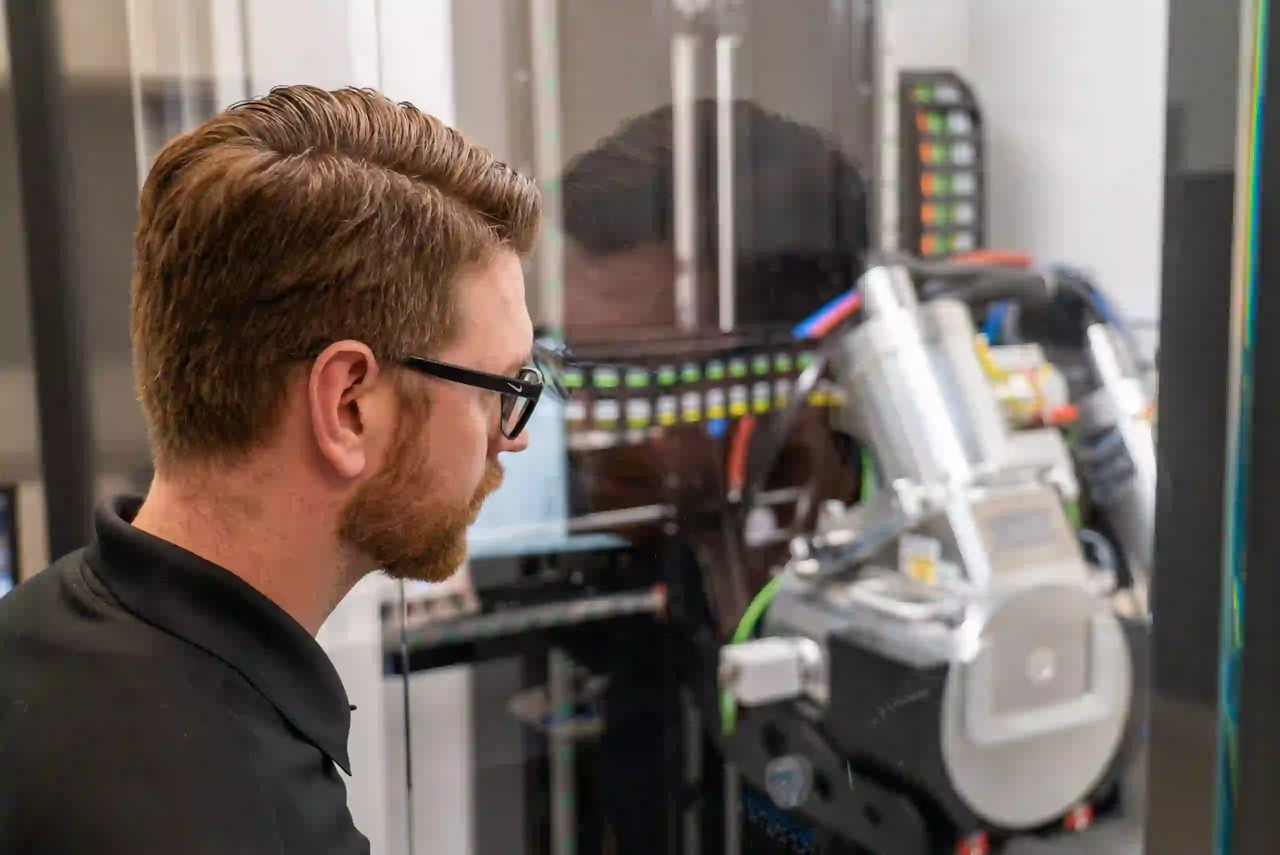 Technician reviewing X-ray inspection results for electronics quality control