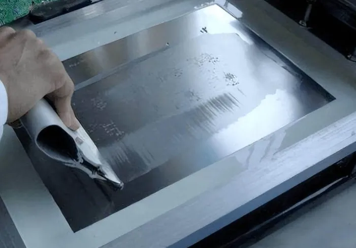 "Solder paste application using a squeegee on a PCB outline stencil."