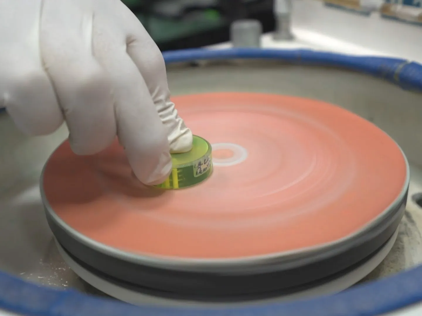 Technician preparing PCB sample for microsectioning in failure analysis