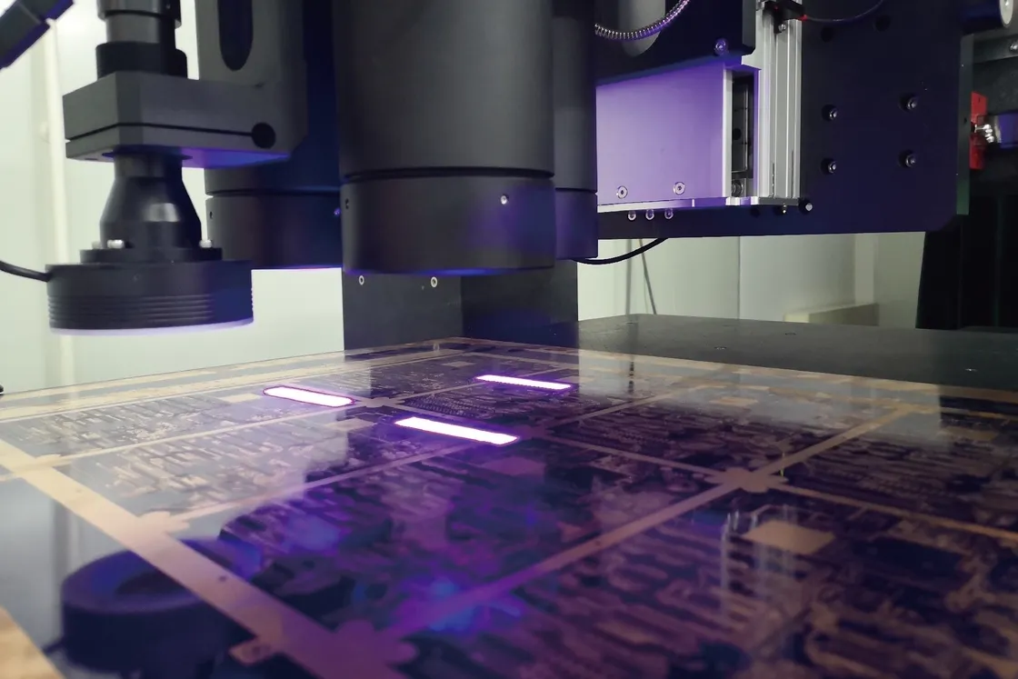 Laser etching machine creating precise PCB traces.