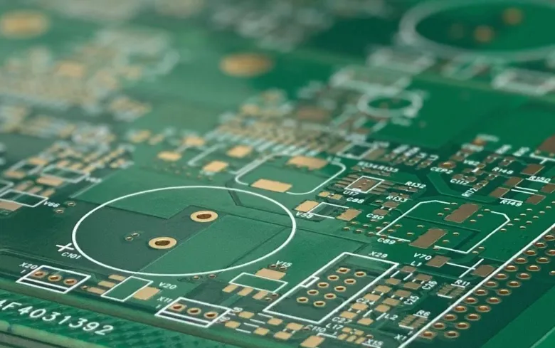 PCB with green solder mask layer protecting copper traces.