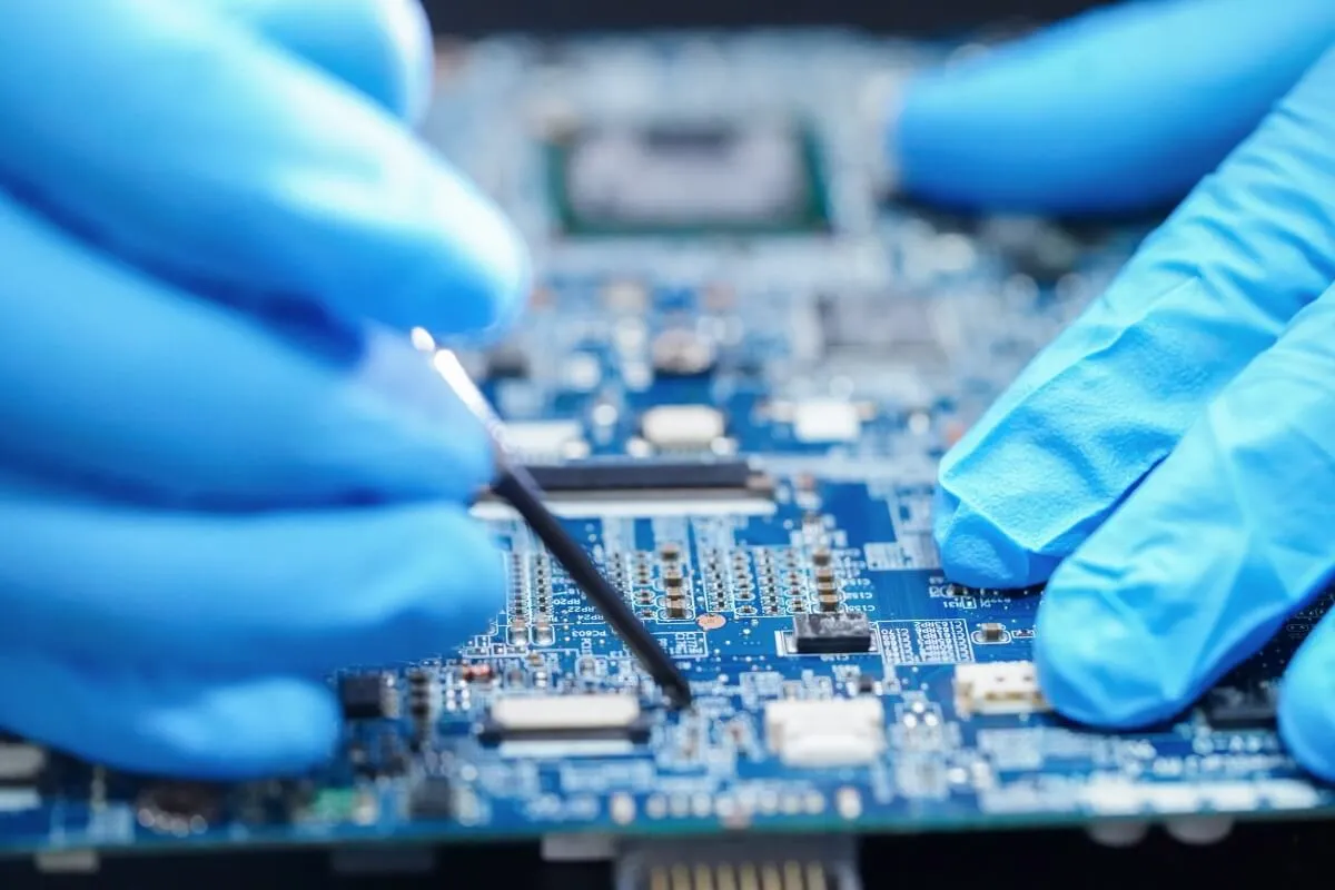 Applying protective coating to a water treatment PCB for moisture resistance.