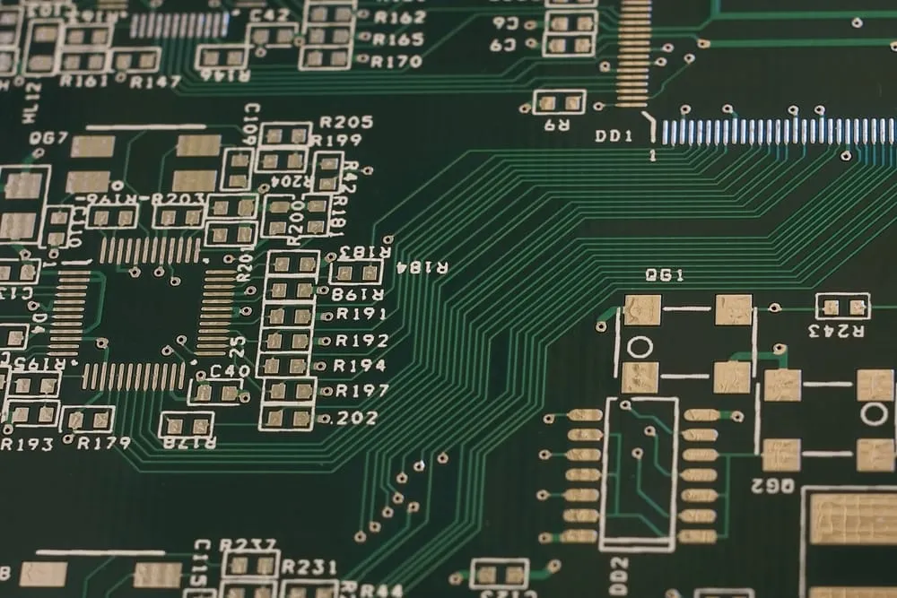 Silkscreen minimum line width on high-density PCB near fine-pitch components.