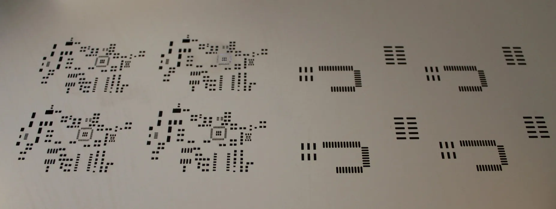Solder paste stencil aligned on a PCB for precise application.