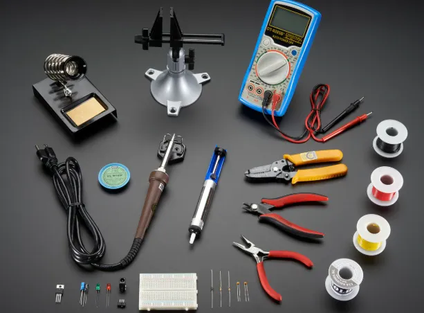 Essential tools for PCB testing displayed on a workbench