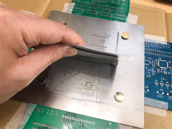 "Stencil printing setup for solder paste application on PCB.