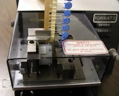 Radial lead forming for a capacitor during PCB assembly.