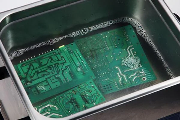PCB cleaning setup with ultrasonic equipment for post-HASL residue removal.