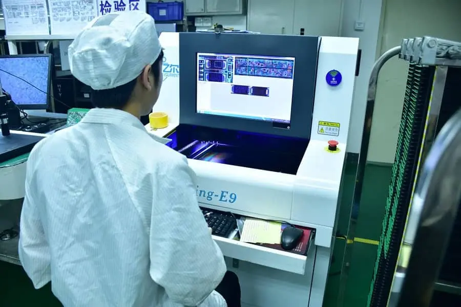 Technician calibrating an AOI system for PCB inspection.