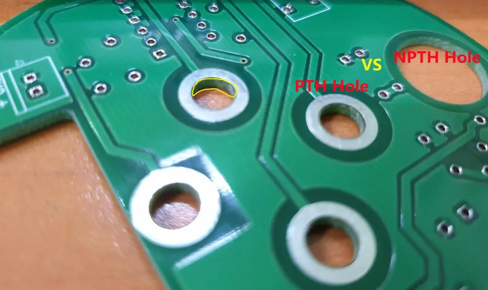 PCB with NPTH mounting holes secured in an enclosure.