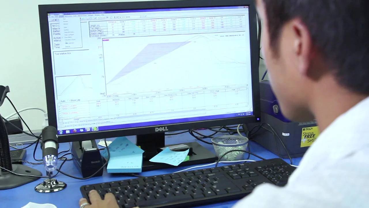 Technician optimizing thermal profile for PCB assembly.